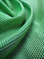 Close-up of green textured fabric with intricate patterns. photo