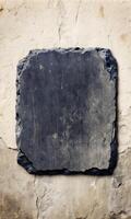 Rustic gray stone slab with rough edges on a weathered backdrop photo