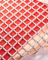 Red and white checkered surface with a textured appearance. photo