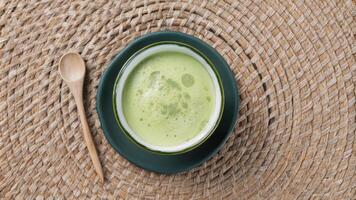 Fresh Green Matcha Tea in Black Ceramic Bowl with Wooden Spoon photo
