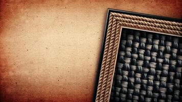 Vintage Textured Frame with Intricate Woven Design on Aged Paper photo