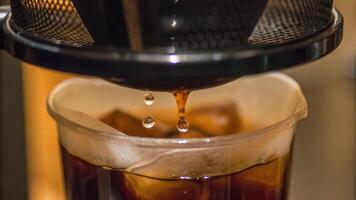 Pouring Freshly Brewed Coffee into Transparent Glass in Cozy Setting photo