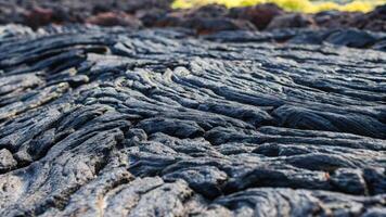 Rough Textured Surface of Dark Lava Rock with Unique Natural Patterns photo