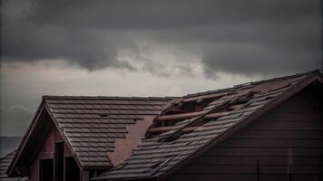 Damaged Roof of a Residential House Under Cloudy Skies photo