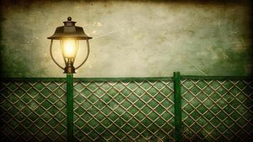 Vintage Lamp Post Against Textured Fence Background photo