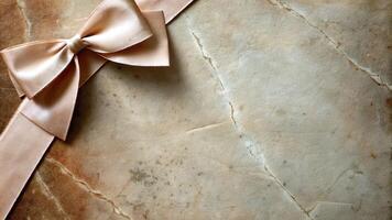 Elegant Golden Bow and Ribbon on Textured Marble Surface photo