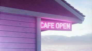 Neon Cafe Sign Illuminated Along a Scenic Coastal Night photo