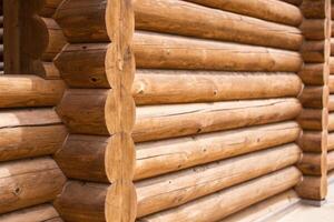Close-Up of Rustic Wooden Log Cabin Wall in Natural Light photo