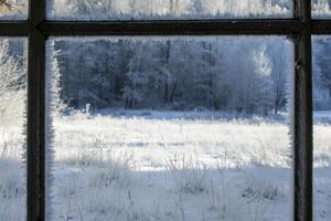 Frosty Winter Landscape Through a Window Frame photo