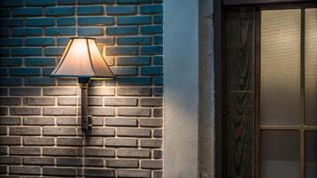 Modern Wall Lamp Casting Light on a Brick Background photo