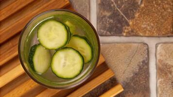 Sliced cucumbers in a refreshing spa water glass. photo
