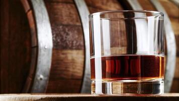 Whiskey Glass with Wooden Barrels in the Background photo