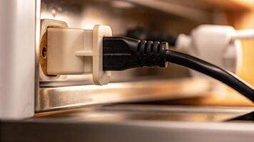 Close-Up of Electrical Plug Inserted into a Socket photo