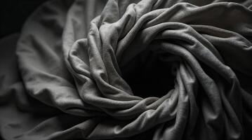 Close-up texture of grey draped fabric with soft folds photo