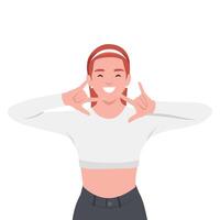 Cheerful woman with a red headband and crop top makes playful hand signs while smiling brightly. vector