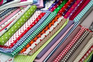 Multicolored textiles on the counter of the store photo