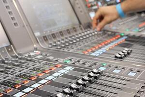 Sound engineer hands adjusting control sound mixer in recording photo