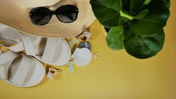 Travel vacation mood layout lifestyle spa wellness concept with beach accessories and copy space. Top view flat lay background, including straw hat, sunglasses, sandals, seashells and pebbles photo