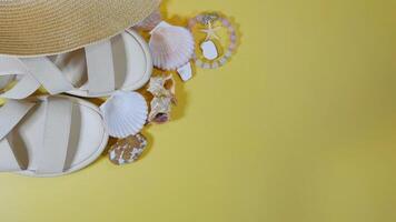 Summer travel vacation mood layout lifestyle spa or wellness concept with beach accessories and copy space. Top view flat lay background, including straw hat, sandals, seashells and pebbles photo