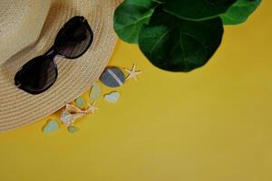 Summer travel vacation mood layout lifestyle spa or wellness concept with beach accessories and copy space. Top view flat lay background, including straw hat, sunglasses, seashells, pebbles photo