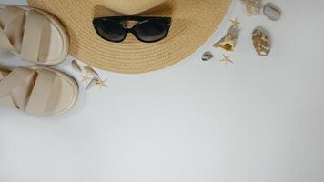 Summer travel vacation mood layout lifestyle spa or wellness concept with beach accessories and copy space. Top view flat lay background, including straw hat, sunglasses, sandals seashells and pebbles photo