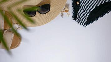 Summer travel vacation mood layout lifestyle spa wellness concept with beach accessories and copy space. Top view flat lay background, including strawhat, sunglasses, swimsuit, seashells and pebbles photo