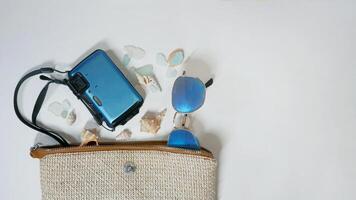 Summer travel mood layout lifestyle spa or wellness concept with beach accessories and copy space. Top view flat lay background, including beach bag, sunglasses, photo camera