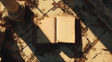 A weathered book lying open on cracked rock in an archaeological setting, bathed in golden light. photo