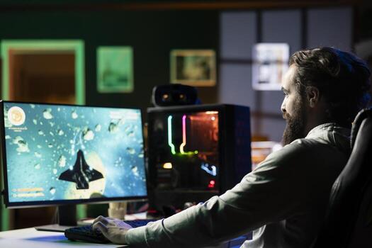 Happy man at home ready to relax by shooting asteroids in spaceship flying singleplayer game. Cheerful gamer sitting in gaming chair, navigating universe in simulation game photo