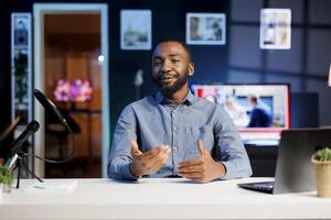 African american content creator doing story time type of for subscribers, filming in personal home studio. Internet show host telling viewers about interesting events, keeping audience engaged photo