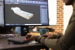Black female developer designing industrial machinery using creative engineering software. Closeup on african american engineer seated at desk, developing digital clamps and tools on a desktop pc. photo