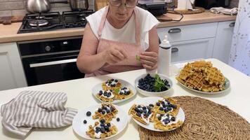 Chef garnishing waffles with mint and blueberries video