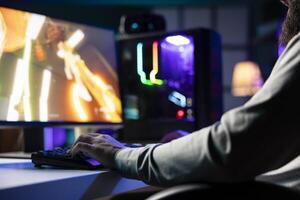 Man playing first person shooter videogame with automatic gun shooting laser bullets at flying robotic foes, close up. Professional gamer competing in PvP online multiplayer game, destroying enemies photo