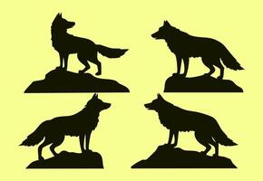 Set of four isolated silhouettes of wolves standing on rocks design illustration vector