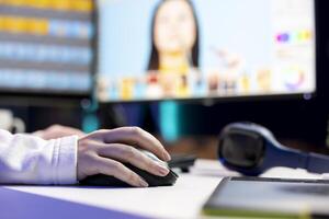 Photo editor color correcting photographs in creative studio using mouse and keyboard, close up shot. Photographer selecting best pictures for editorial content using retouching software