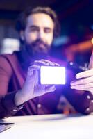 Close up shot of mini led lights, reviewed by tech guru filming technology videos. Focus on filming equipment shown by online star in blurry background to subscribers, talking in mic photo