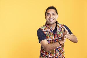 Portrait of joyous spectator grinning and clapping hands, acclaiming entertainers, studio background. Radiant person pleased by spectacle, doing handclapping gesture during standing ovation photo