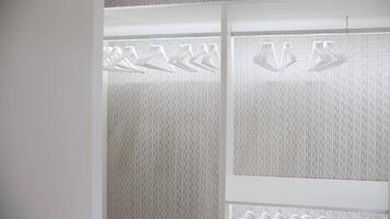 White wardrobe with hangers and built-in lighting video