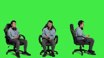 Gamer feeling angry about losing games competition against greenscreen, playing on console with controller and gaming setup. Irritated displeased woman lost shooter action. Camera A. photo