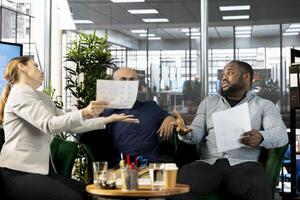 Annoyed manager unhappy with employees struggling to implement business strategies to improve profitability. Irked company director displeased after failing to achieve revenue performance targets photo