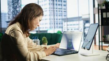 Powerful female director developing corporate innovation plan, exploring new possibilities and business models to enhance the enterprise advantage. Evaluating reports and data analytics. Camera A. photo