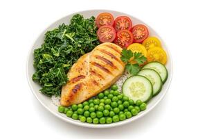 a bowl of food with chicken, vegetables and peas photo