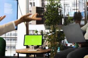 Green screen tablet next to employees implementing strategy to guide organization towards growth. Mockup device next to worker working to achieve performance targets for operational efficiency photo