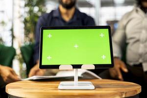 Board of directors in office maintaining strong relationships with business partners, looking at metrics on green screen tablet. Company director shows shareholders data on chroma key device, closeup photo