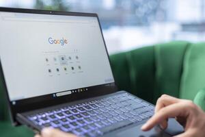 Bucharest, Romania - July 30th 2024 - Man selects MAX bookmark on Google search engine, preparing to use HBO streaming services to watch a movie on laptop in his personal office. Corporation. photo
