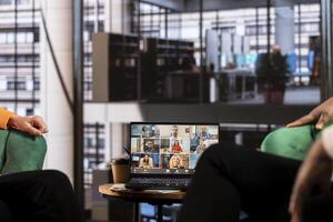 Multicultural team of women leaders hold an online conference call, showcasing collaboration and career growth in a professional, remote setting. Entrepreneurs discuss with investors group. photo