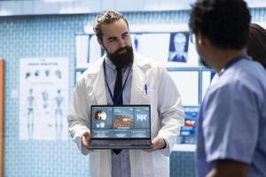 Professional medic analyzing mri brain scan with his staff in medical office, neuroscientist examining tomography with diverse team of doctors. Experts in neuroscience at treatment center. photo