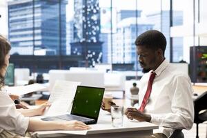 HR experts look at CVs on isolated screen laptop to vet selected applicants and ensure their skills match role needs. Headhunters read resumes on mockup notebook, assessing candidate work experience photo