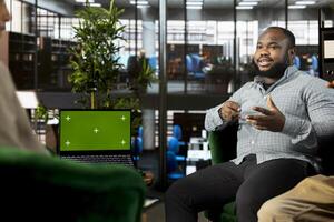 Isolated screen laptop used by coworkers preparing for business meeting, having discussion. Chroma key notebook used by teamworking employees doing research analysis for startup organization photo
