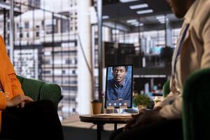 Multicultural team of businesswomen leads an online presentation, showcasing their leadership and success in a remote work environment. Sharing ideas with their boss on call. photo